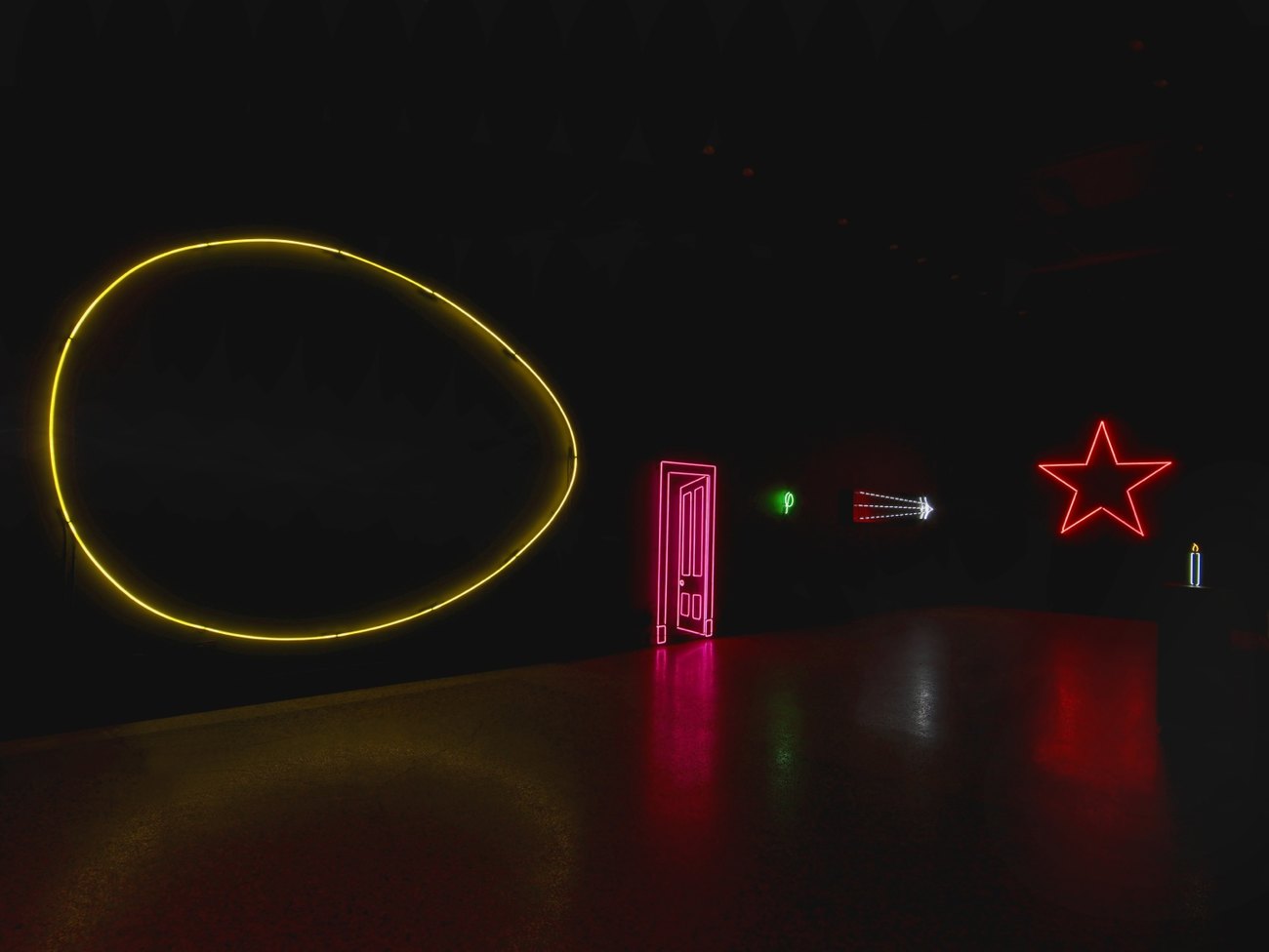 large yellow neon outline of an egg, red neon door, red neon start, all against black backdrop