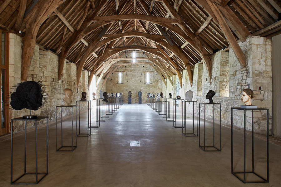 The picture shows a series of sculptures of busts, from a number of different artists 