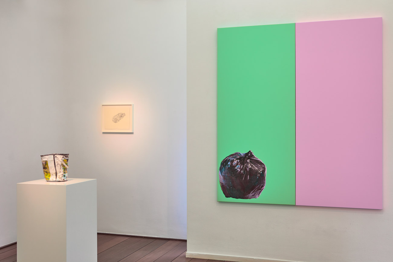 The image shows three artworks by Gavin Turk, one diptych painting green and pink with a trash bag, one bronze artwork of a used paint pot and a water colour of a bottle