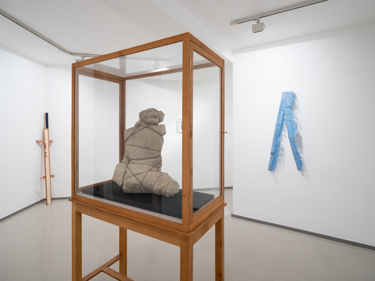 Installation photo shows Gavin's work centred, looks like a wrapped disformed figure
