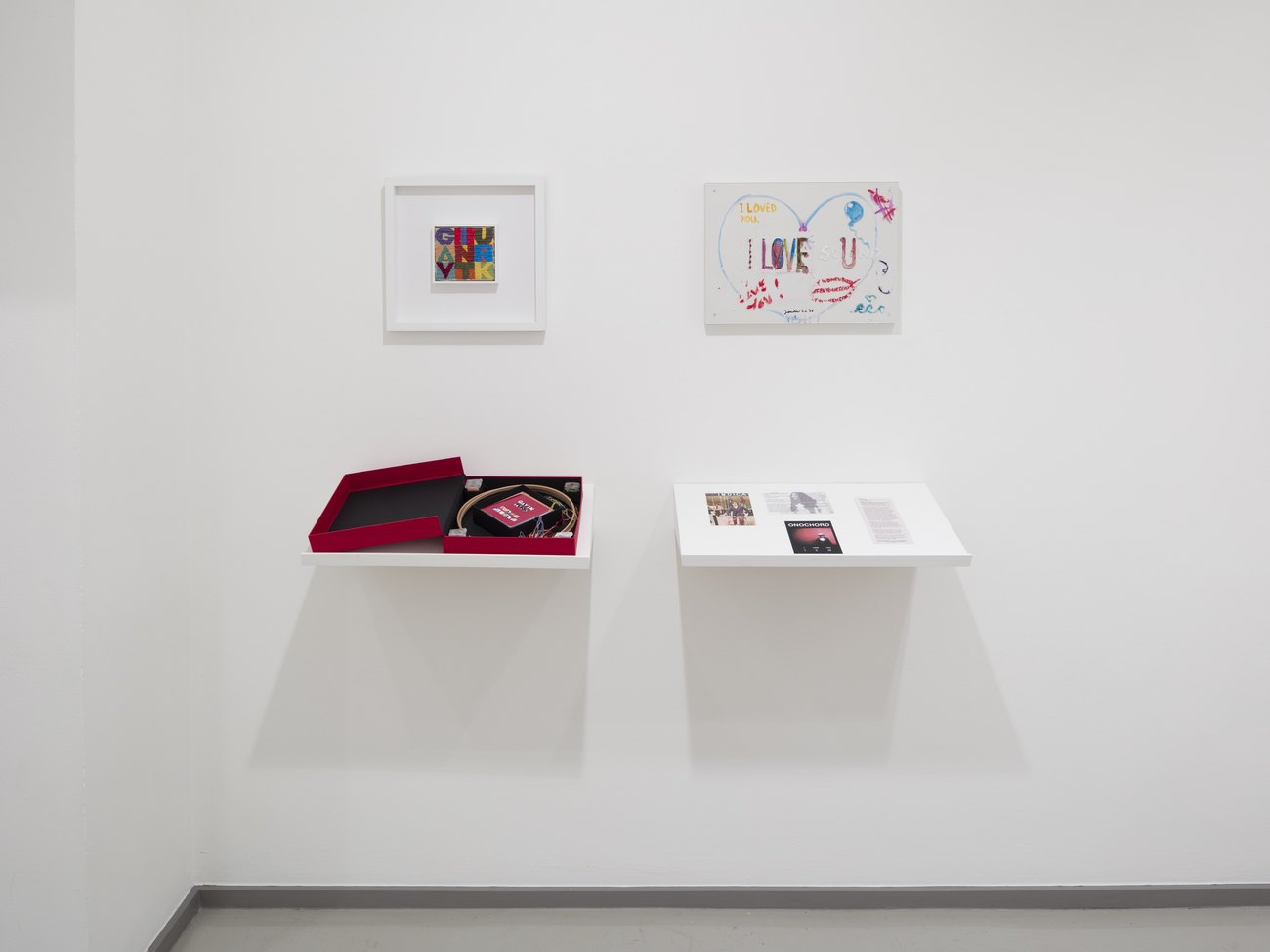 Image shows two artworks one by Gavin Turk, an embroidery 9 panel with Gavin Turk written 