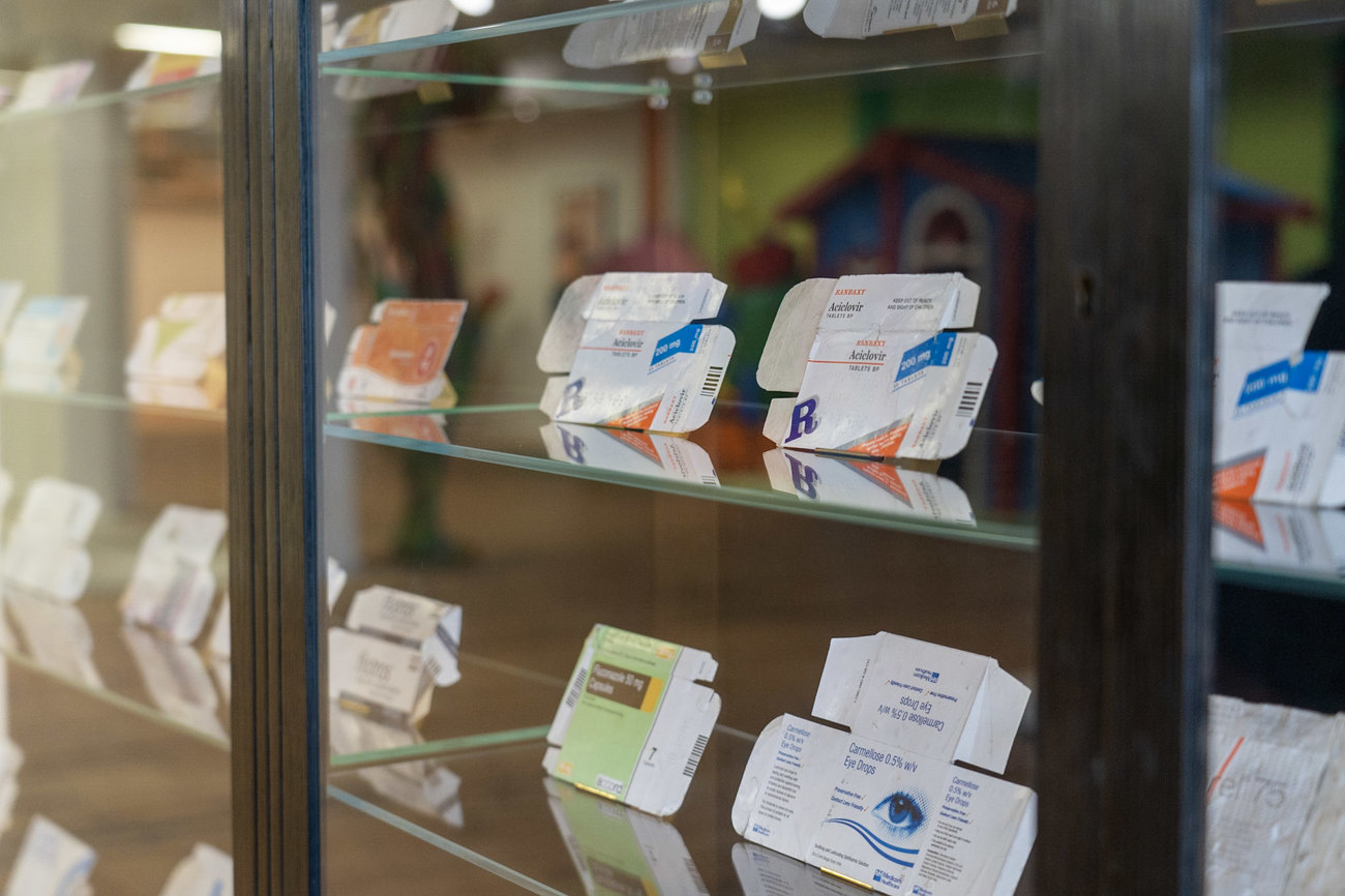 Detailed shot of a cabinet filled with flattened, discarded and used medicine packets