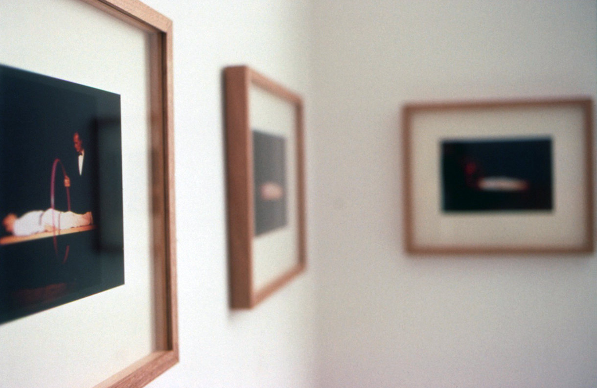 Photo shows three framed still from the magic trick by the artist