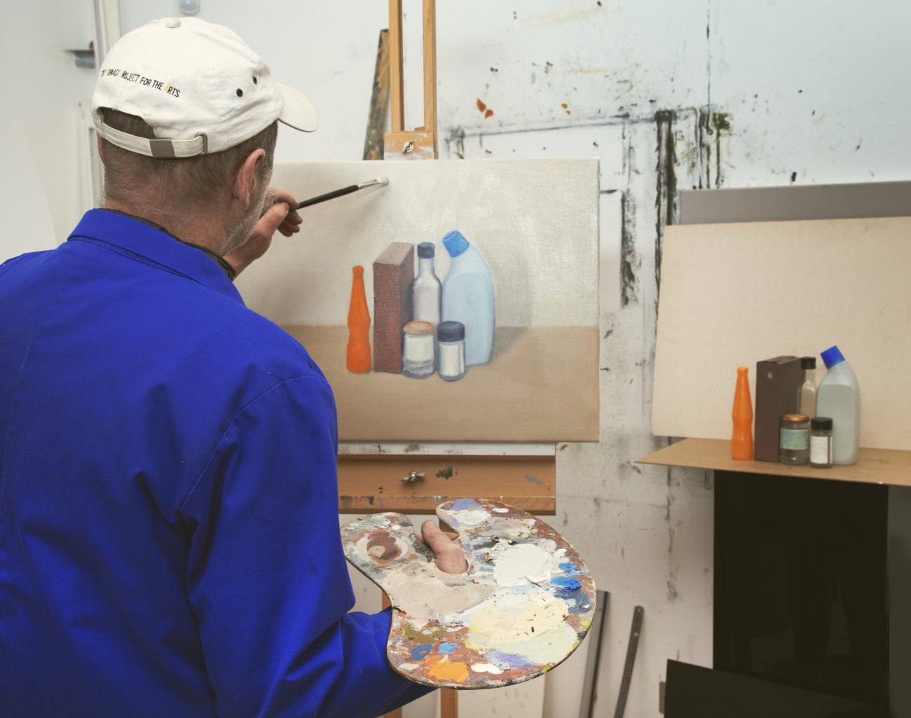 The photo shows Gavin Turk painting a still life 