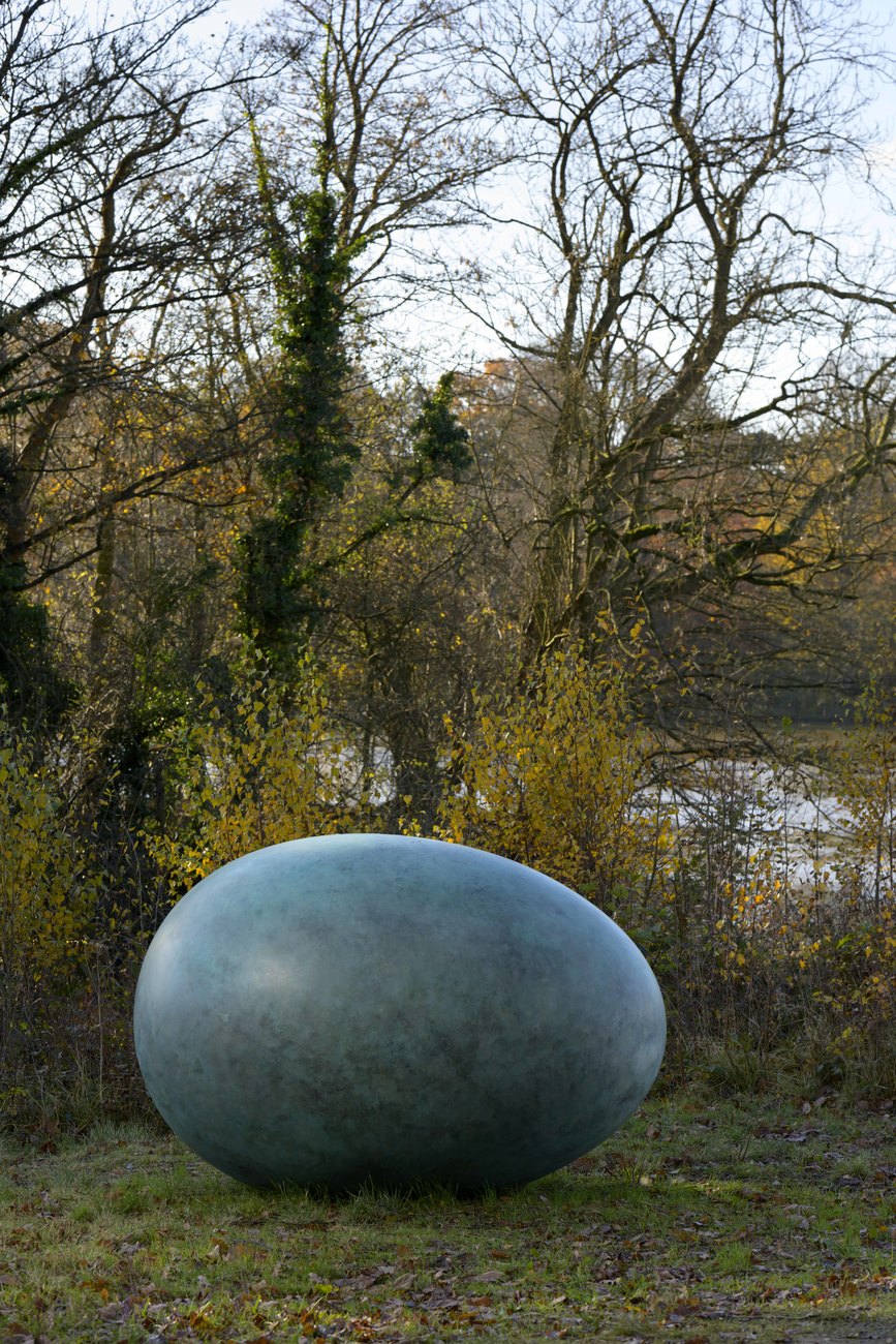 Bronze Sculpture of a Duck egg exhibited in front of a duck pond