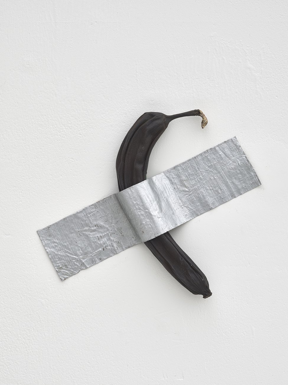 Photo shows artwork by Gavin Turk, of a banana cast in bronze