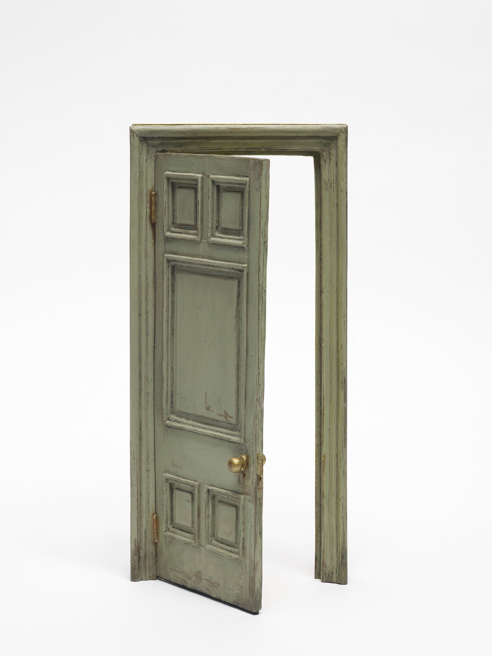 Image shows a small door made of bronze