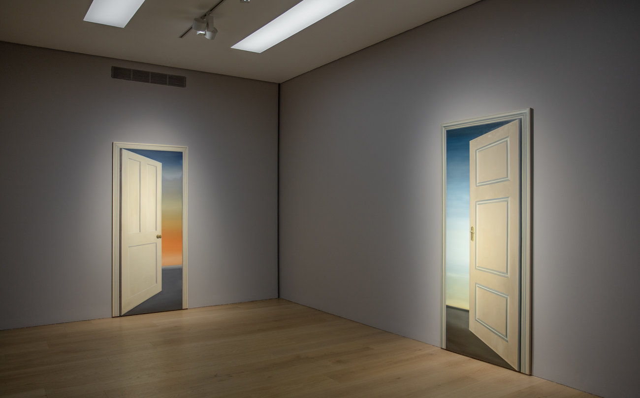 Photo of an exhibition of artwork by Gavin Turk, of paintings of doorways 